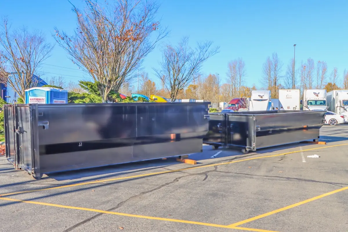 Professional dumpster rental service with roll-off container on residential driveway in North Star
